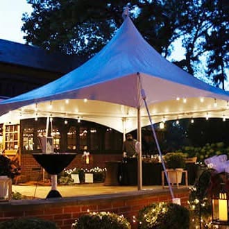 Tent setup at dusk with string lights